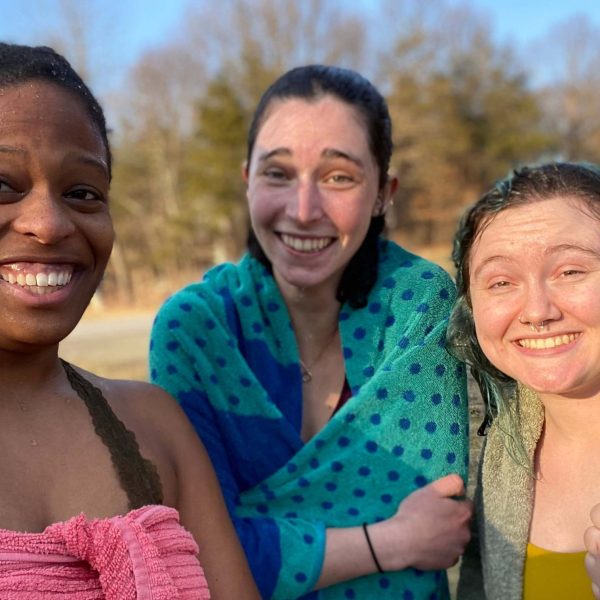 Gabi and two friends smile for a selfie while wrapped in towels. They are drying off after having gone swimming.