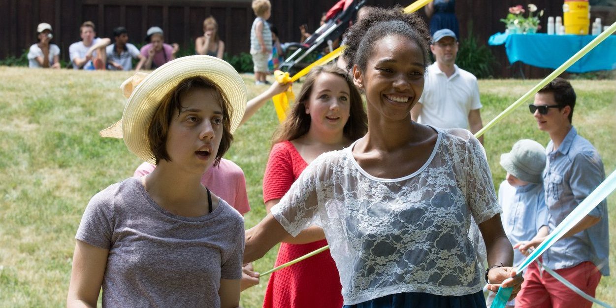 People of all ages dance around a maypole at Camphill