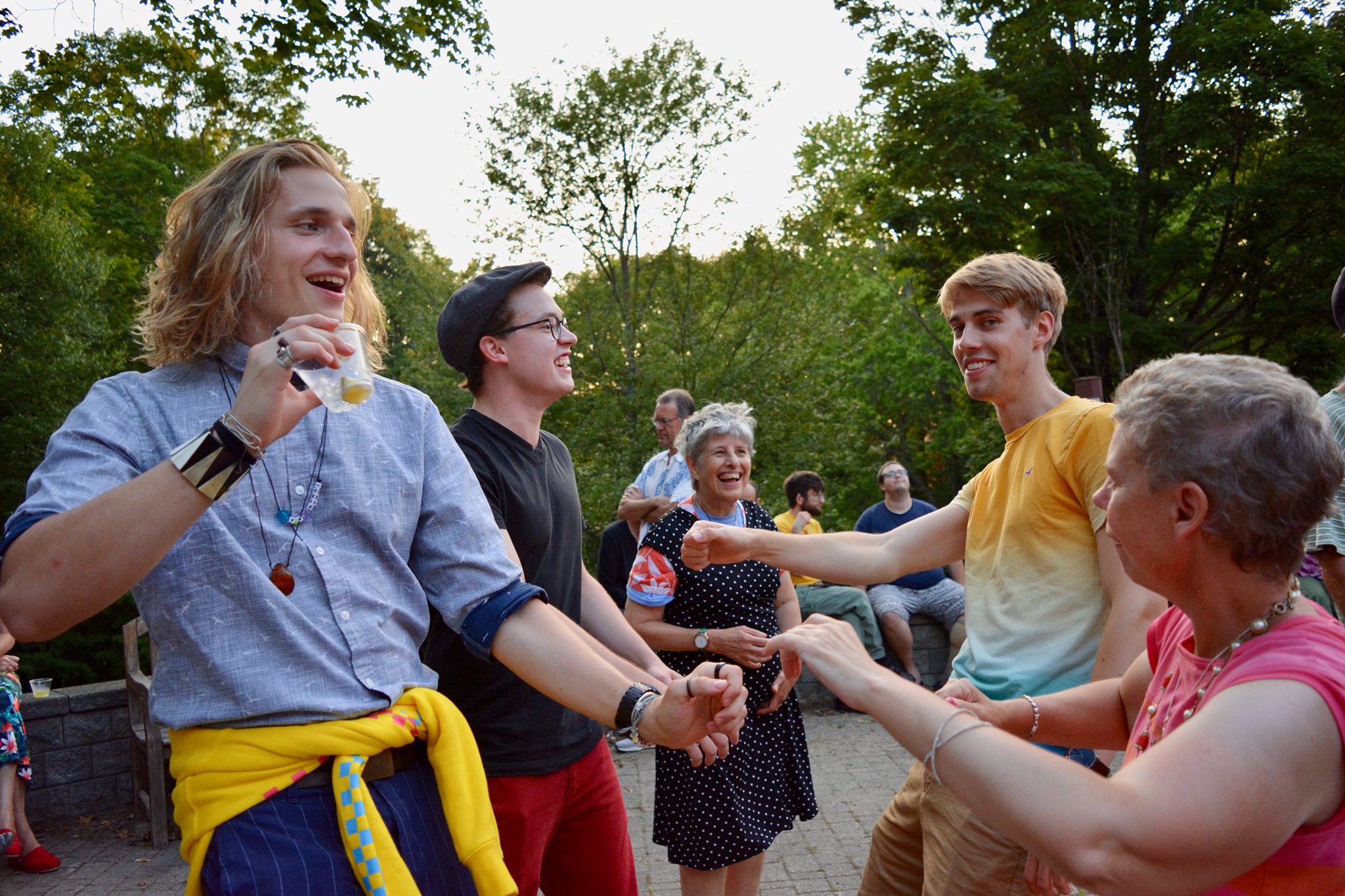 People laugh and dance together outdoors