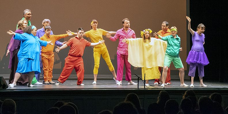 A group of people in colorful costumes onstage