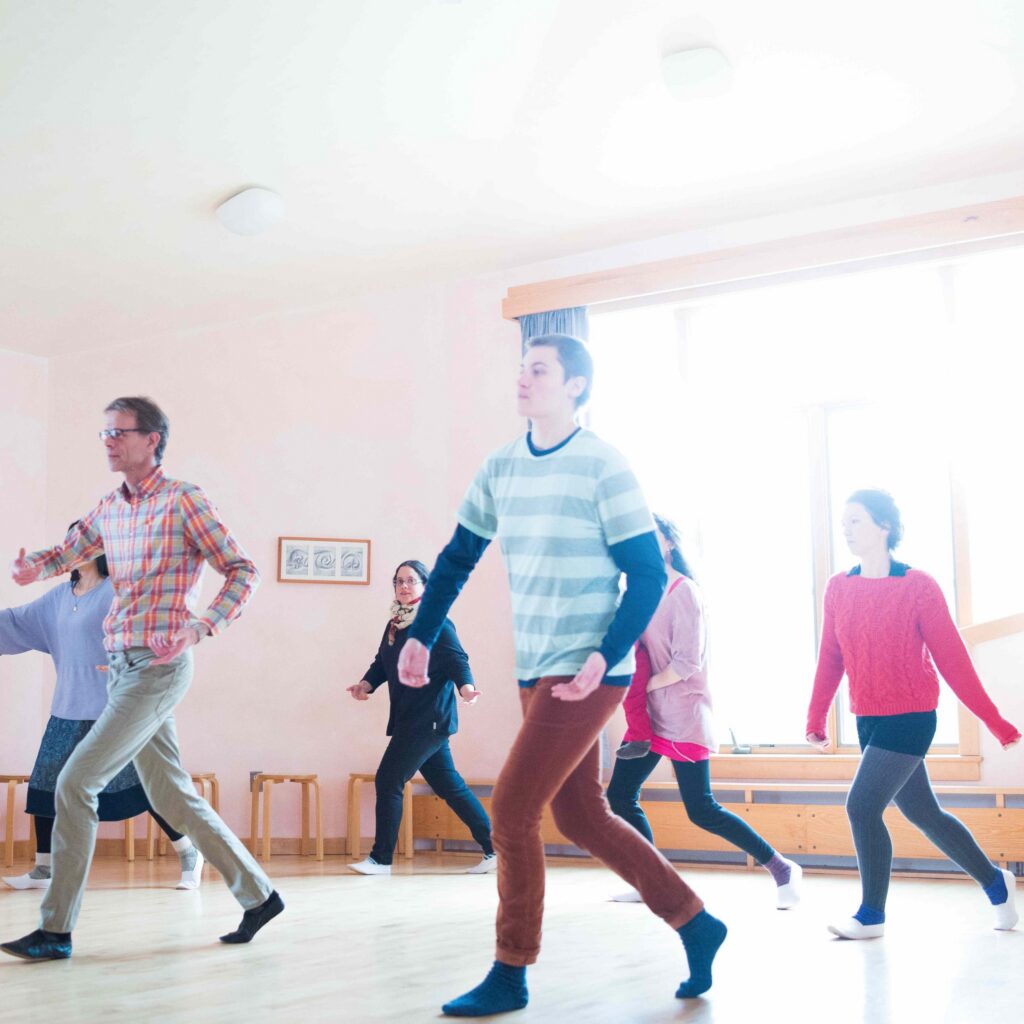 A group of people dancing together in a dance class