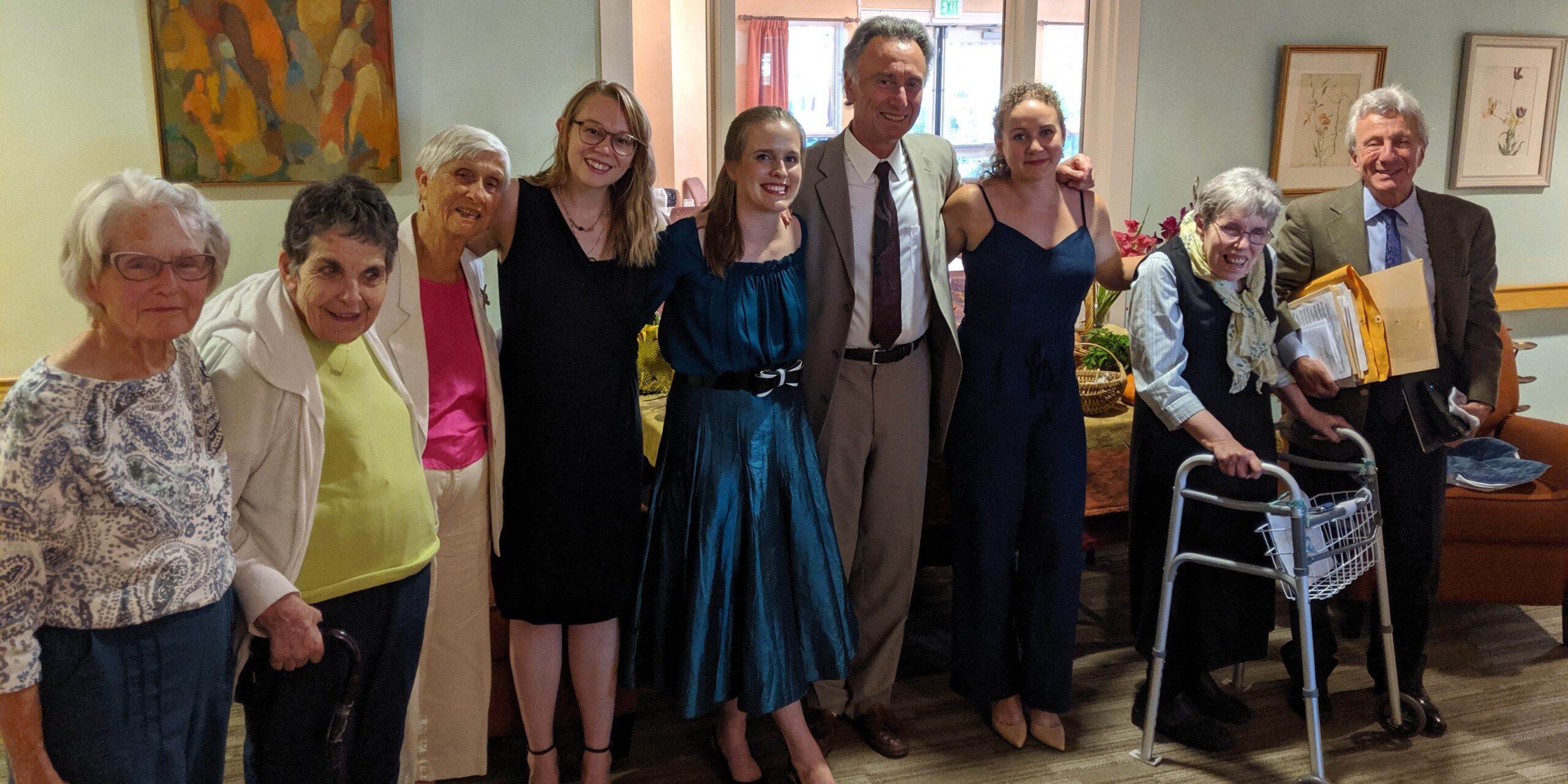 A group of older and younger adults pose together for the camera