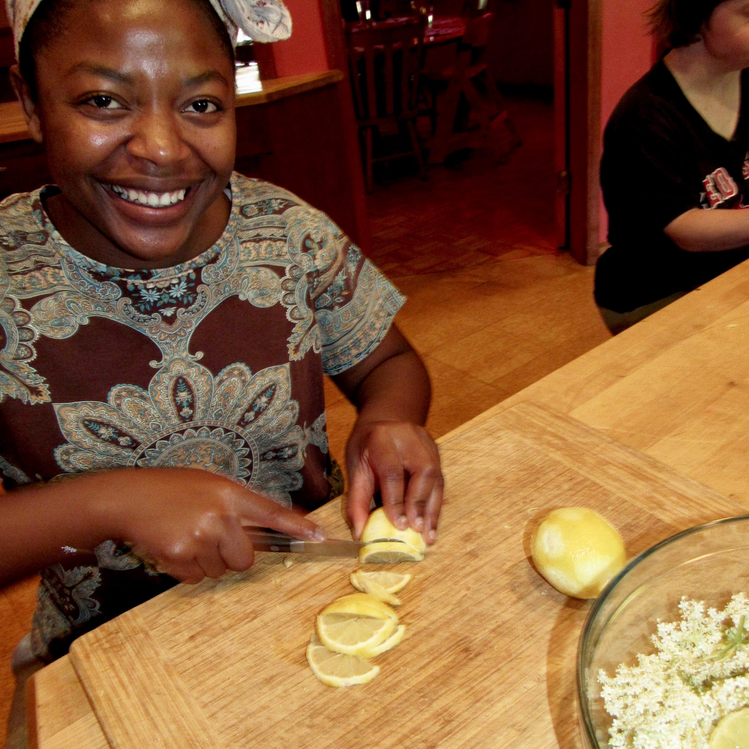 Slicing lemons to steep with the elderflowers