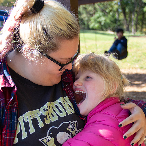 Two friends hugging and smiling