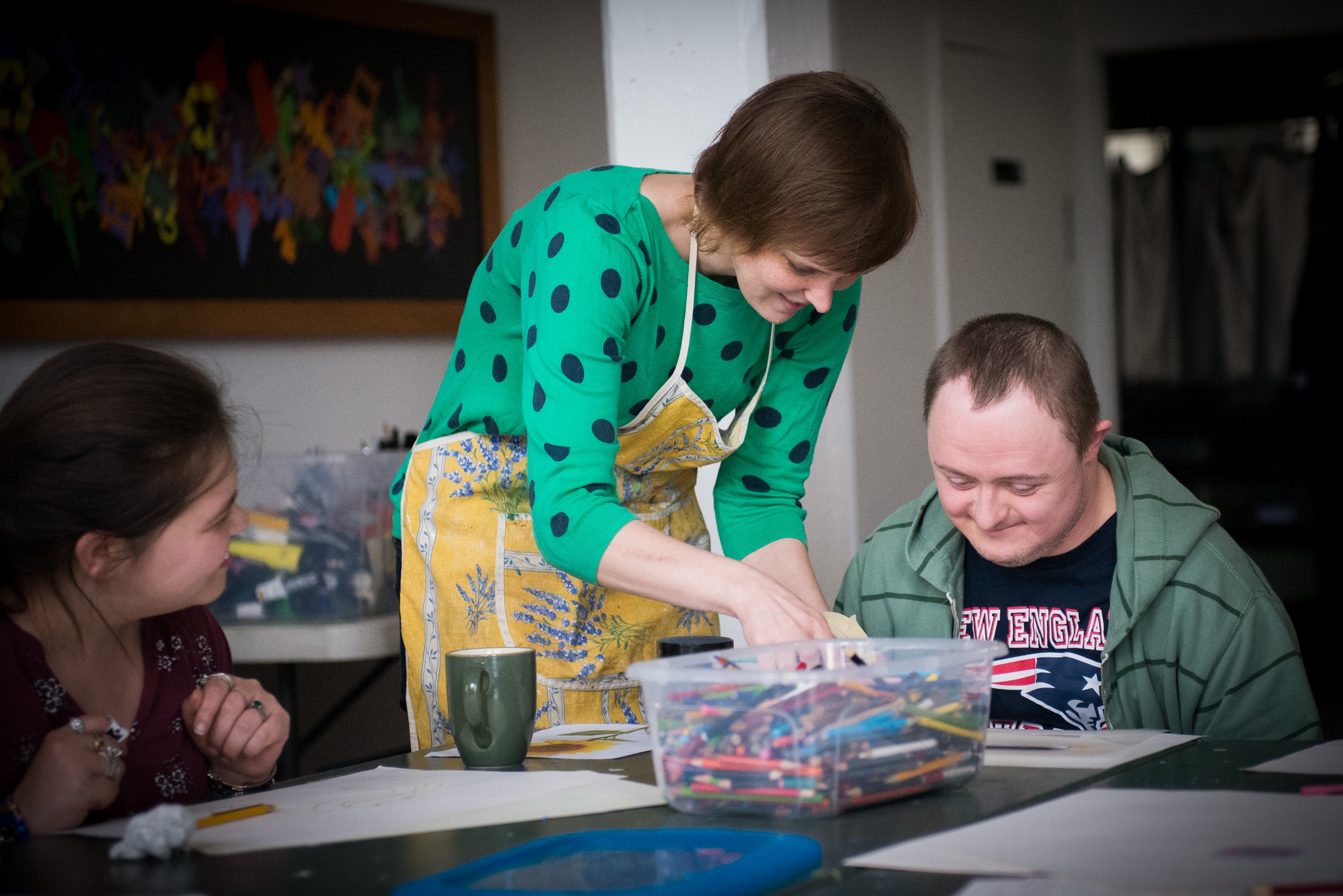 Adults in an art class drawing flowers