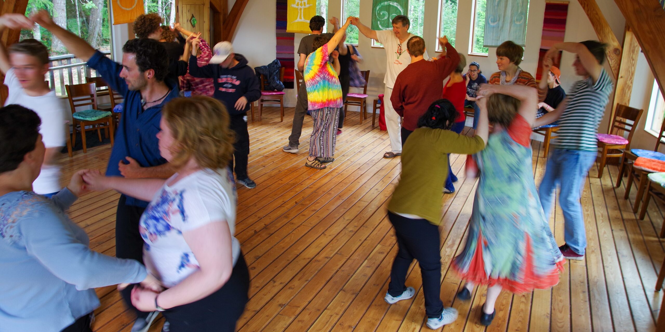People of all ages dancing together indoors