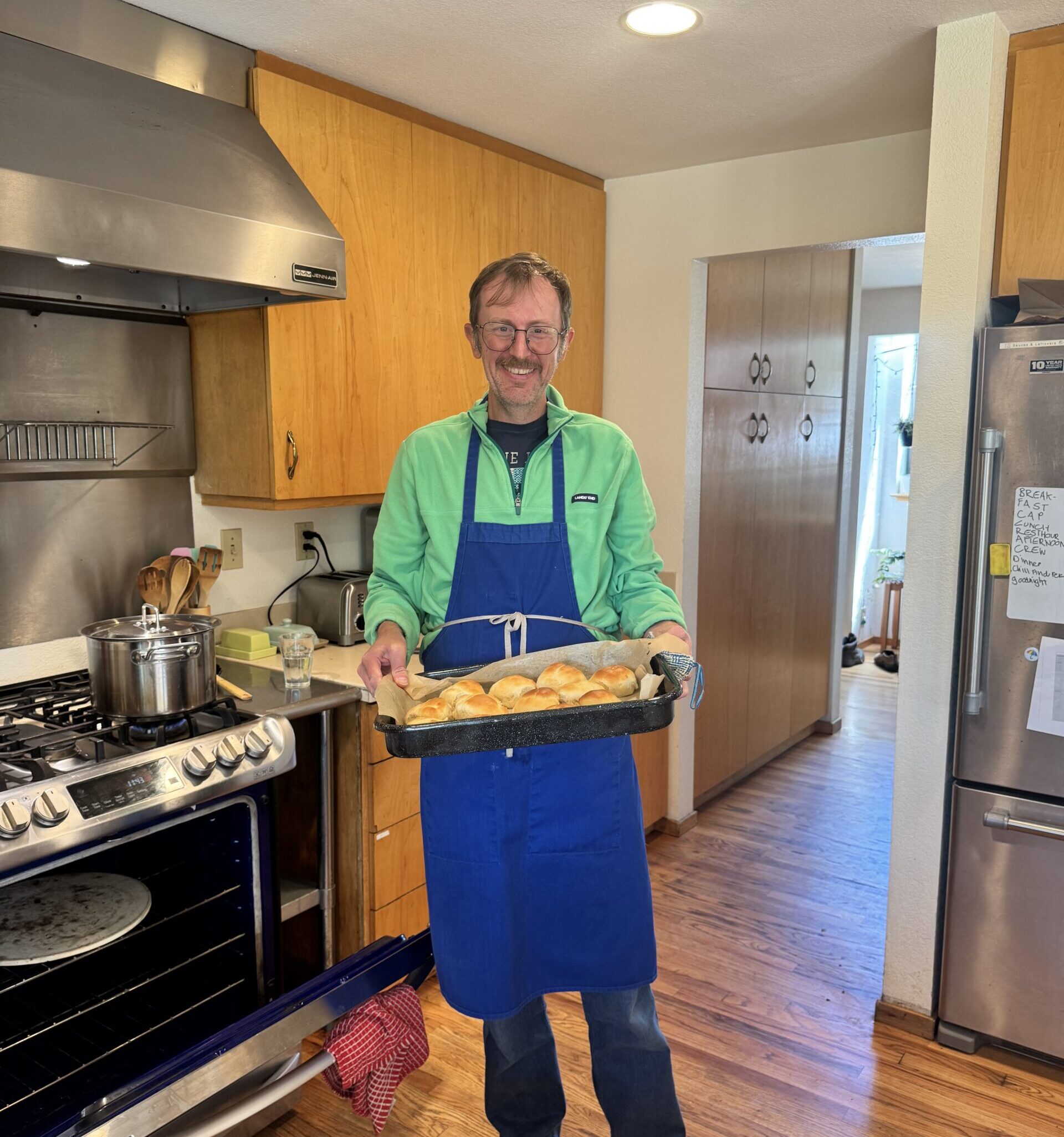 Sasha wears his blue apron while baking