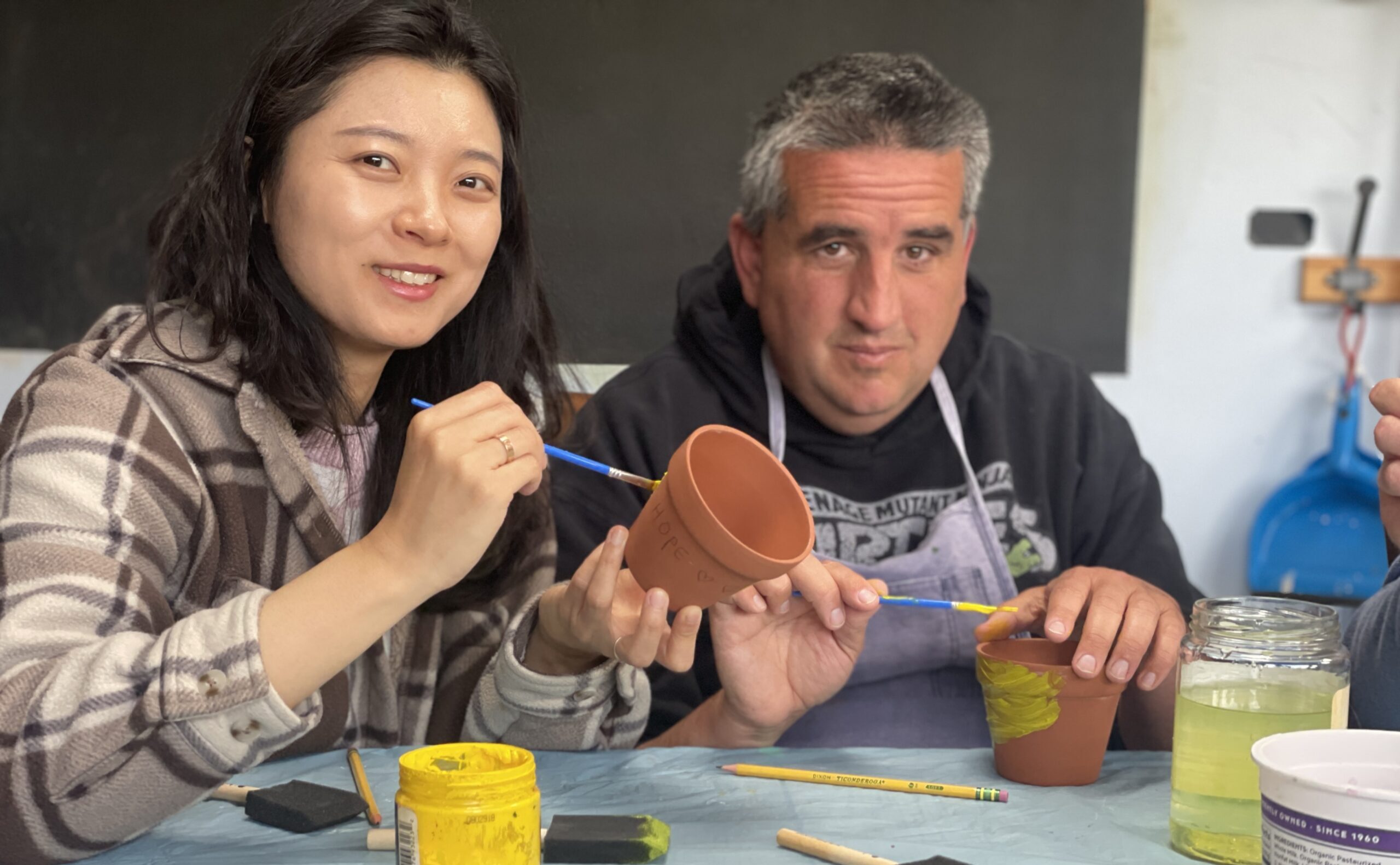 Coleman and Lim Painting a pot